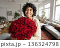 Happy young woman holding red roses in modern apartment, love, romance and Valentines Day lifestyle concept 136324798