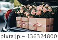 Gift boxes and flowers in open car trunk, romantic surprise and care concept 136324800
