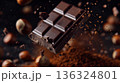 Macro chocolate bar breaking with flying crumbs and cocoa, dark chocolate and food texture concept 136324801