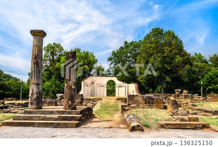 Old Alabama State Capitol ruins in Tuscaloosa. Historic site features stone columns and foundation remains in Capitol Park under a blue sky 136325150