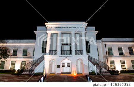 Colleton County Courthouse in Walterboro, South Carolina. Historic white building features columns and stairs at 101 Hampton Street at night 136325358