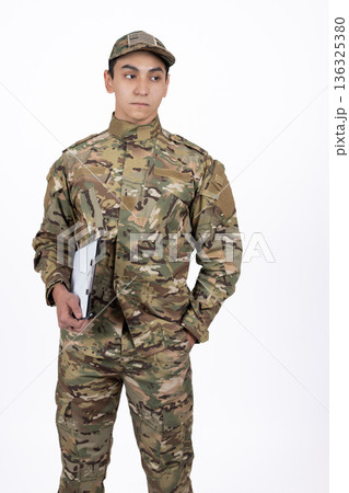 Soldier in camouflage holding a folder and looking at camera Soldier in camouflage holding a folder and looking at camera 136325380