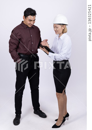 Female engineer and male architect working with documents 136325421