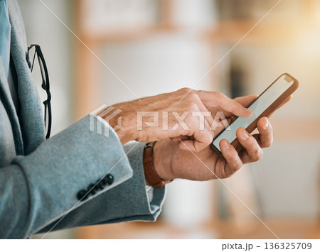 Business man, hands and phone screen at desk with networking, text and online communication. App, mobile message and social media browse in a office and workplace with contact and typing at company Business man, hands and phone screen at desk with networking, text and online communication. App, mobile message and social media browse in a office and workplace with contact and typing at company 136325709