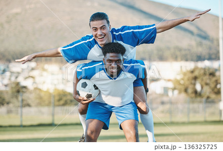 Soccer player, support or team in celebration for goal, victory or success on a field in sports game together. Black man, piggyback or excited football players winning a fitness match achievement Soccer player, support or team in celebration for goal, victory or success on a field in sports game together. Black man, piggyback or excited football players winning a fitness match achievement 136325725