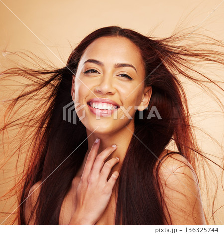 Hair care, beauty and portrait of happy woman with wind, luxury salon treatment and brown background. Smile, haircut and haircare, face of model with natural cosmetics and keratin shine in studio. Hair care, beauty and portrait of happy woman with wind, luxury salon treatment and brown background. Smile, haircut and haircare, face of model with natural cosmetics and keratin shine in studio. 136325744