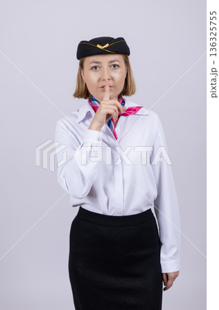 Air stewardess in professional uniform posing in studio 136325755