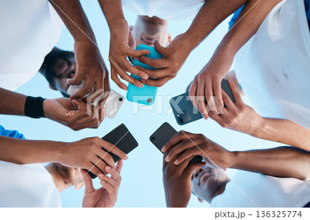 Hands, phone and app with people in a huddle or circle for communication or connectivity. Mobile, social media or information sharing with a group of men networking together closeup from below Hands, phone and app with people in a huddle or circle for communication or connectivity. Mobile, social media or information sharing with a group of men networking together closeup from below 136325774