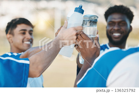 Success, happy and men in soccer with water bottle after a game, sports win or celebration after training. Smile, drink and athlete people with a toast for achievement, motivation or goal in football 136325792