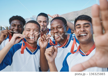 Men in selfie, medal and winner, soccer competition and sports, athlete group on field, diversity and success. Portrait, young male football player and team with smile in picture, winning and prize 136325865