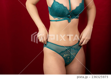 Close up of woman wearing green lace lingerie 136325973
