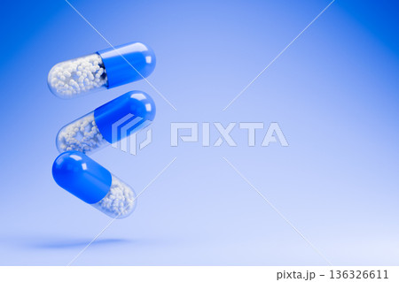 Blue capsules and pills flying on a light blue background 3d 136326611