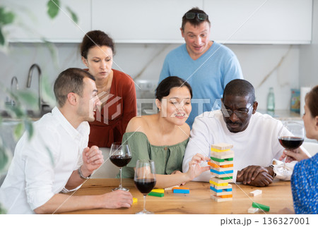 Multiethnic women and men friends playing bricks 136327001