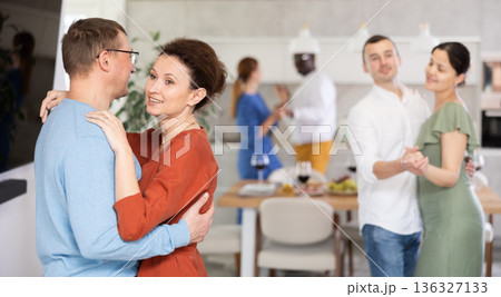 Happy middle-aged men and women doing slow dance in pairs 136327133