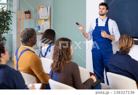 Male mentor teaches students new skills in vocational fields Male mentor teaches students new skills in vocational fields 136327136