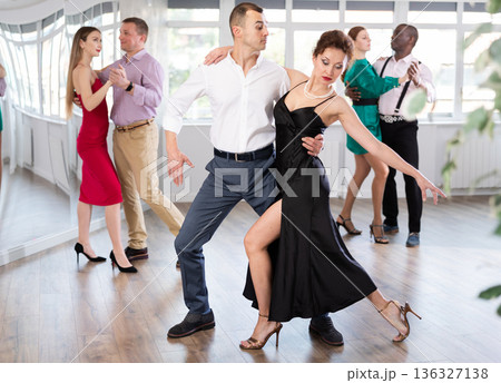 Woman and young man practicing waltz in dancing studio Woman and young man practicing waltz in dancing studio 136327138