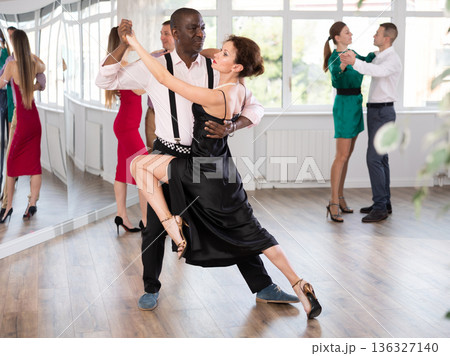 Middle-aged man and woman practicing waltz in dancing studio 136327140