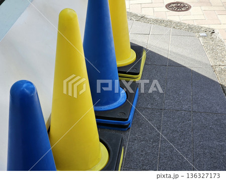 Blue and Yellow Traffic Cones on a Sidewalk in Tokyo. Blue and Yellow Traffic Cones on a Sidewalk in Tokyo. 136327173