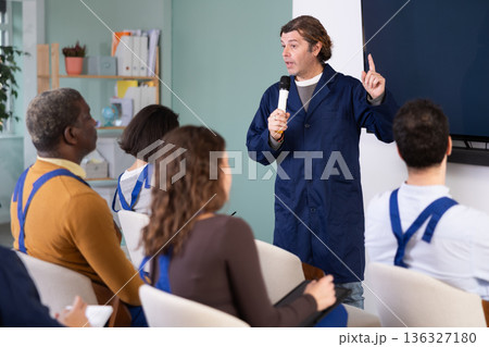 Male mentor teaches students new skills in vocational fields Male mentor teaches students new skills in vocational fields 136327180