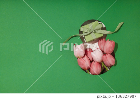 Pink tulips and a small gift create a cheerful spring scene Pink tulips and a small gift create a cheerful spring scene 136327987