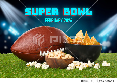 Enjoying tasty nachos and popcorn while watching the Super Bowl 136328024