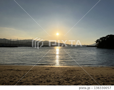 穏やかな海に沈む夕日と水面に輝くサンセットの反射 穏やかな海に沈む夕日と水面に輝くサンセットの反射 136330057