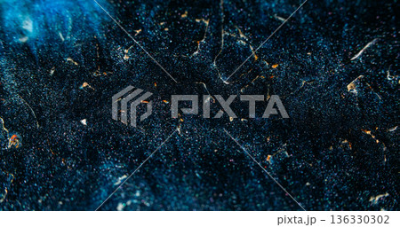 Dark shimmering texture. Grunge shine. Yellow golden flare on black blue ink ash abstract blur background. Glowing night color volcanic sand. Dark shimmering texture. Grunge shine. Yellow golden flare on black blue ink ash abstract blur background. Glowing night color volcanic sand. 136330302