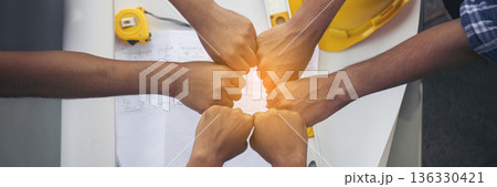 Banner Close up engineer men hands diversity multiethnic partners team together. Group of multiracial engineer Manager Foreman Teamwork meeting. Top view team join hands partnership with copy space 136330421