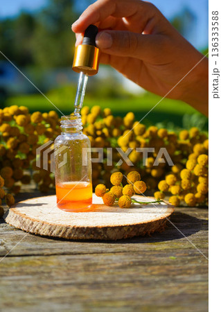 tansy medicinal extract, tincture, decoction, oil, in a small bottle nature tansy medicinal extract, tincture, decoction, oil, in a small bottle nature 136333588