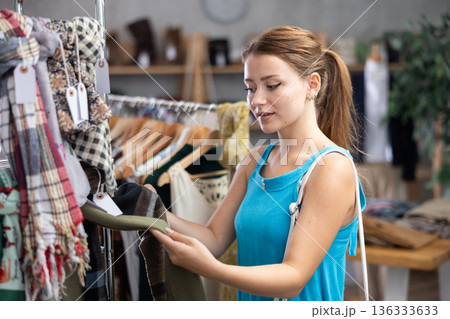 Woman choosing a scarf in a store 136333633