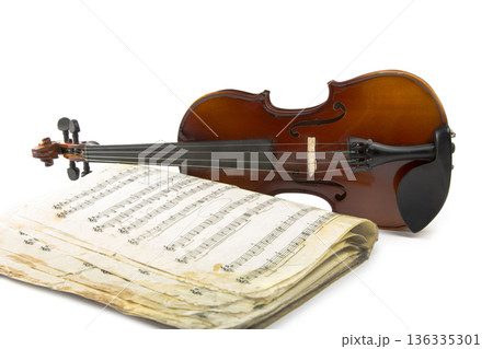 Still life with a violin and music book on a white background 136335301