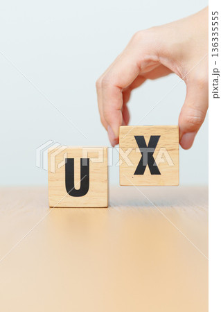 hand change wooden block of UX. UI, User Interface and User Experience, Usability, Information Architecture, IA, Research, Prototype, Testing, Onboarding, Design Thinking and Wireframe concepts hand change wooden block of UX. UI, User Interface and User Experience, Usability, Information Architecture, IA, Research, Prototype, Testing, Onboarding, Design Thinking and Wireframe concepts 136335555
