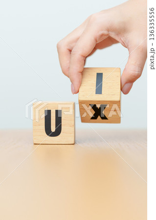 hand change wooden block from UI to UX. User Interface and User Experience, Usability, Information Architecture, IA, Research, Prototype, Testing, Onboarding, Design Thinking and Wireframe concepts 136335556