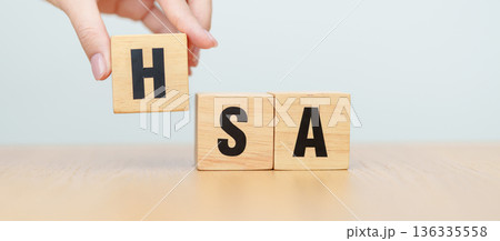 hand change wooden block from FSA. HSA, Flexible Spending Account and Health Savings Account, Medical Expenses, Tax Benefits and healthcare concepts hand change wooden block from FSA. HSA, Flexible Spending Account and Health Savings Account, Medical Expenses, Tax Benefits and healthcare concepts 136335558