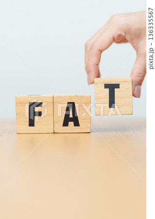 wooden block FAT. Fitness, Exercise, Healthy, Wellness, motivation and wellbeing concepts wooden block FAT. Fitness, Exercise, Healthy, Wellness, motivation and wellbeing concepts 136335567
