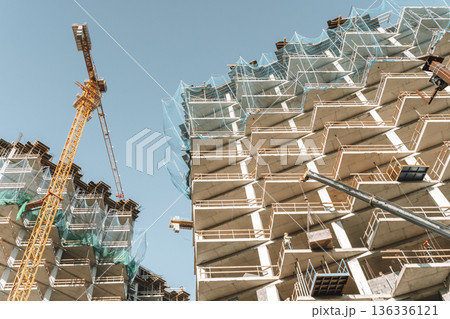Construction of a building. Construction site with crane. Business, development, industry. Construction of a building. Construction site with crane. Business, development, industry. 136336121