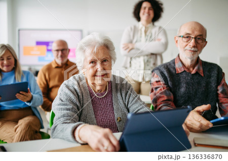 Elderly woman learning digital skills with tutor help. Elderly woman learning digital skills with tutor help. 136336870