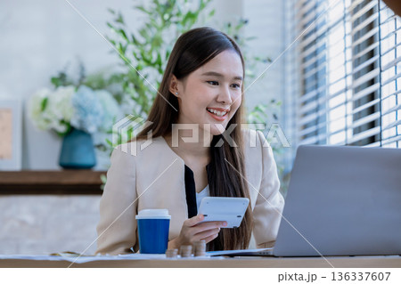 Business woman at desk in office for celebration of goals or target.  136337607