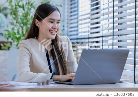 Business woman at desk in office for celebration of goals or target.  136337608