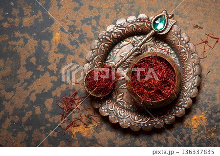 Vibrant Saffron Threads In An Ornate Bowl On Textured Surface 136337835
