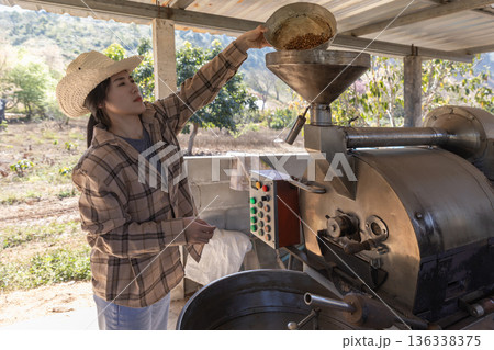 Coffee processing. Coffee roasting machine with arabica beans in stainless steel cooling bin. Coffee processing. Coffee roasting machine with arabica beans in stainless steel cooling bin. 136338375