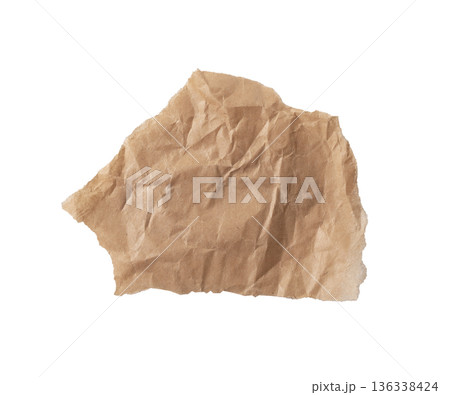 Crumpled brown kraft paper piece with deep wrinkles, rough torn and teared edges, and irregular Crumpled brown kraft paper piece with deep wrinkles, rough torn and teared edges, and irregular 136338424