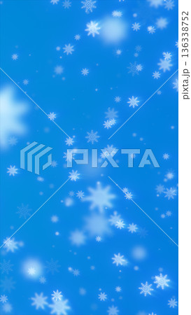 Soft falling white snowflakes drifting across a bright blue winter background 136338752