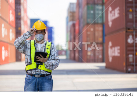 Foreman or worker work at Container cargo site check up goods in container.  136339143