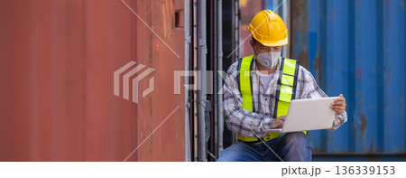 Foreman or worker work at Container cargo site check up goods in container.  136339153