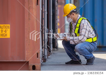 Foreman or worker work at Container cargo site check up goods in container. Foreman or worker work at Container cargo site check up goods in container. 136339154