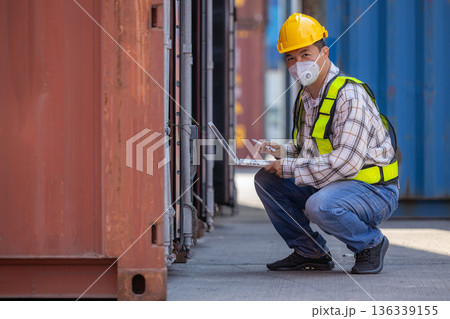 Foreman or worker work at Container cargo site check up goods in container.  136339155
