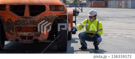 Foreman or worker work at Container cargo site check up goods in container.  136339172