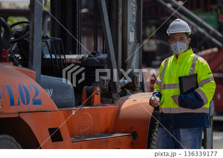 Foreman or worker work at Container cargo site check up goods in container. Foreman or worker work at Container cargo site check up goods in container. 136339177