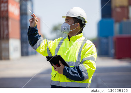Foreman or worker work at Container cargo site check up goods in container. Foreman or worker work at Container cargo site check up goods in container. 136339196